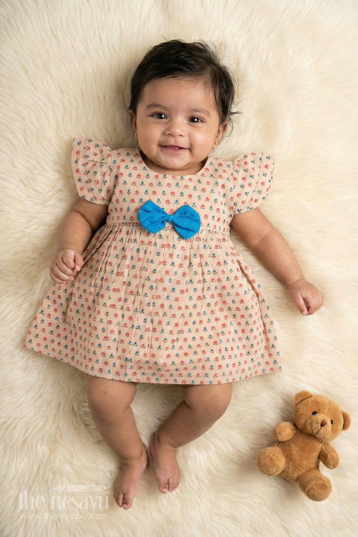 The Nesavu Baby Cotton Frocks Beige Floral Print Cotton Baby Frock for Girls with Blue Bow Accent Nesavu 10 (NB) / Beige BFJ562A-10 Beige Floral Print Cotton Baby Frock for Girls with Blue Bow Accent Nesavu