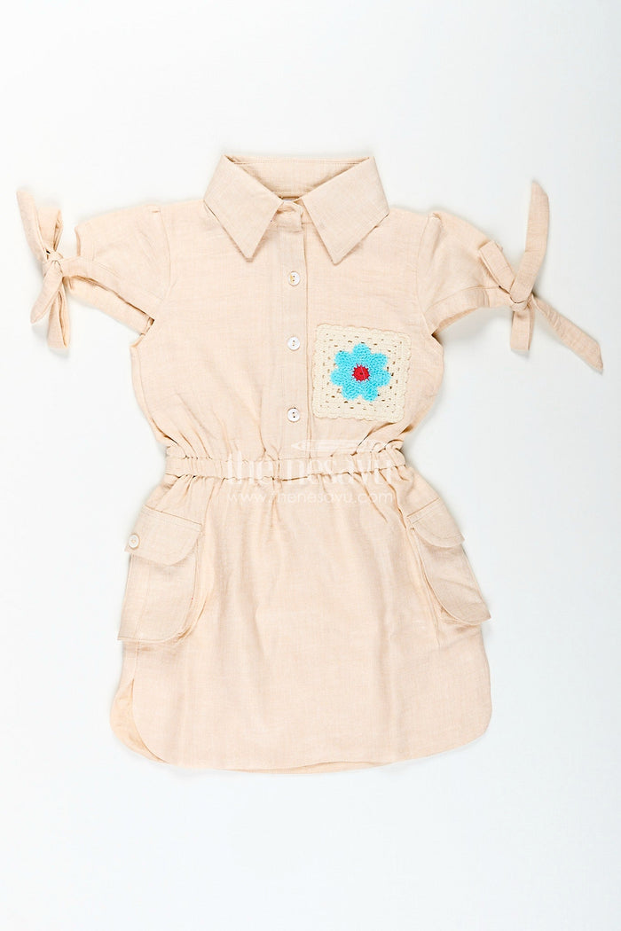 The Nesavu Girls Cotton Frock Beige girls cotton frock with collar and crochet flower patch Nesavu Nesavu beige girls cotton frock with collar and hand-crochet flower patch