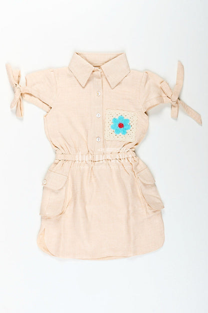The Nesavu Girls Cotton Frock Beige girls cotton frock with collar and crochet flower patch Nesavu Nesavu beige girls cotton frock with collar and hand-crochet flower patch