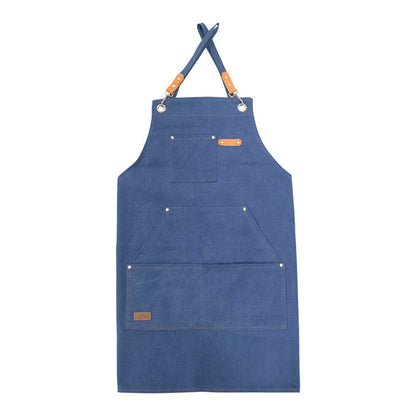 Canvas utility apron in navy waxed cotton on white background