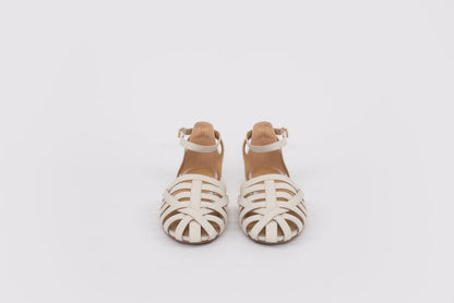 large sized womens Pair of white sandals with brown straps on a light gray background