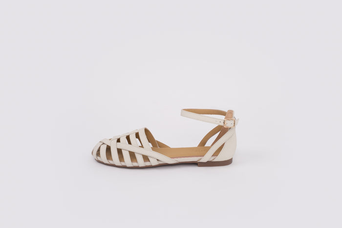size 9 womens Beige flat shoe with zebra pattern sole on a white background