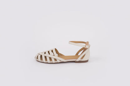 size 9 womens Beige flat shoe with zebra pattern sole on a white background