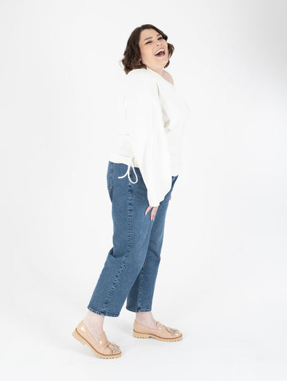 Tall woman wearing beige glossy loafers available in sizes 42 43 44 45 46 standard and wide fit