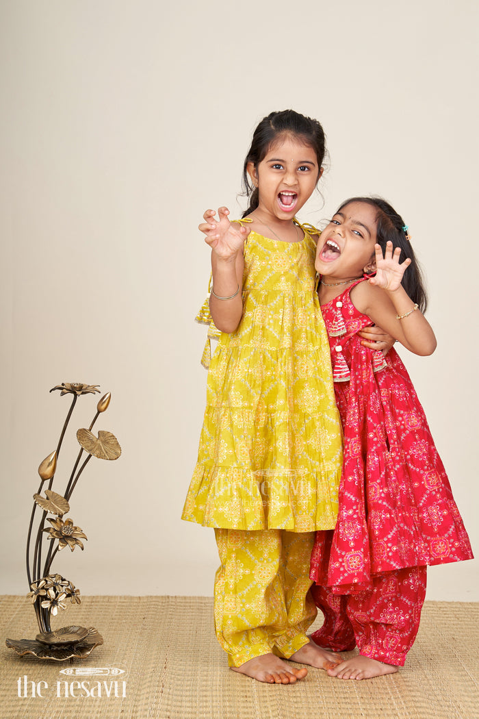 The Nesavu Girls Sharara / Plazo Set Girls yellow sharara set with printed tiered kurti for festive dressing Nesavu Nesavu girls yellow cotton sharara set with tiered flared kurti and digital print for festive wear