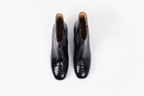 Izzy Boot by Otto + Ivy - an aerial profile of a black boot for tall women with large feet, featuring glossy black croc leather and a low chunky heel.