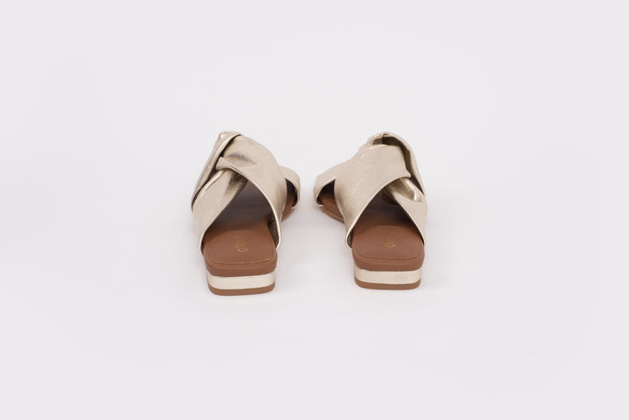 Back shot of gold slip on sandal in gold. Available in larger womens sizes 8-12