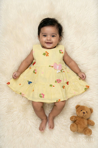 The Nesavu Baby Cotton Frocks Muslin Cotton Frock for Baby Girl's Summer Playdates and Casual Wear Nesavu 14 (6M) / Yellow / Cotton Blend BFJ910B-14 Nesavu muslin cotton frock with floral embroidery and butterfly patch for baby girl summer wear