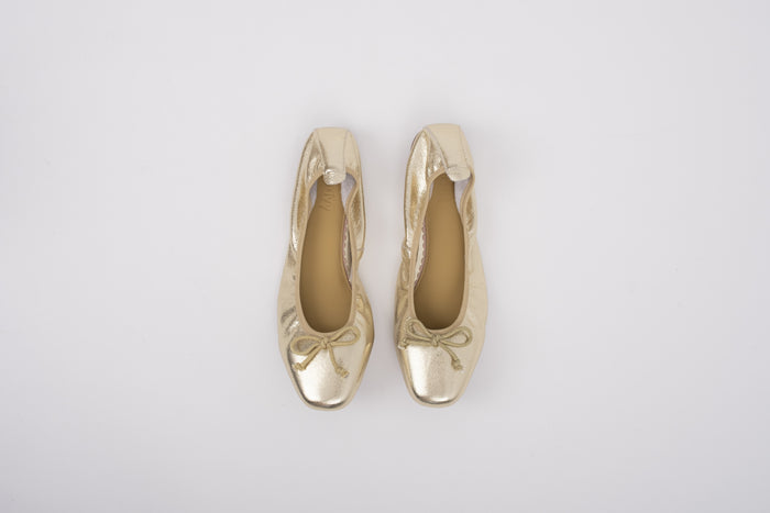 Aerial shot of womens gold ballet flats in large sizes 8 9 10 11 12