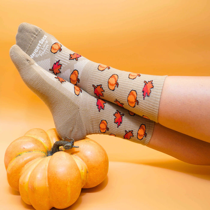 Run Luxe socks, Crew length, Brown with fall leaves and pumpkin logos.