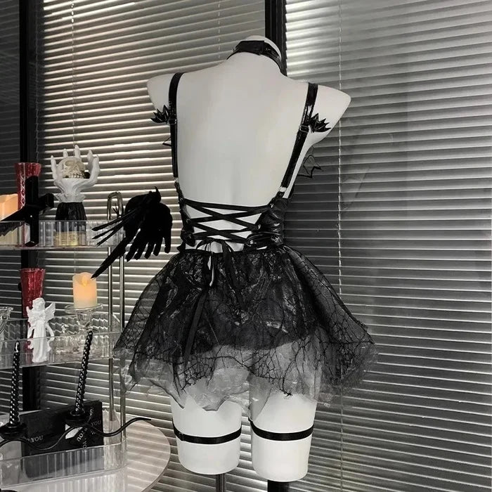 Black lace dress on a mannequin against a window with blinds
