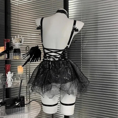 Black lace dress on a mannequin against a window with blinds