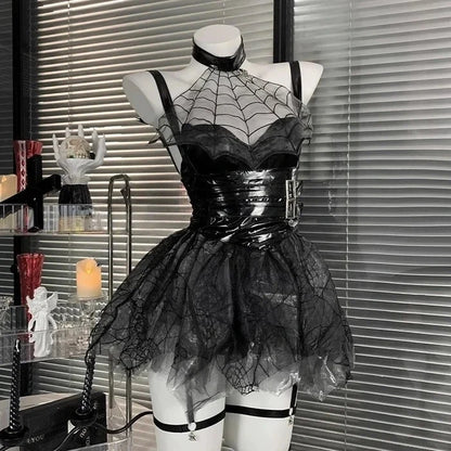 Black lace and vinyl dress on a mannequin against a window with blinds.