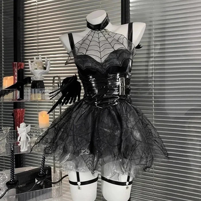 Black spiderweb dress on a mannequin against a window with blinds.