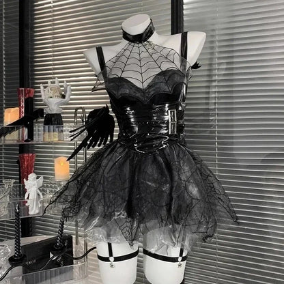 Black spiderweb dress on a mannequin against a window with blinds.