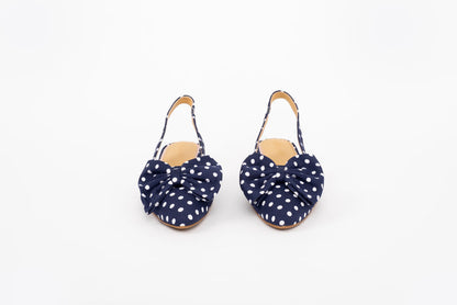 Front shot of bow heeled kitten Delilah in navy polka in European sizes 42-46