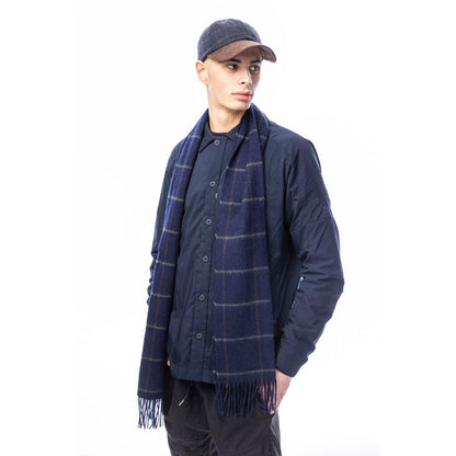 Male model wearing a blue box check baseball cap standing in front of a white background